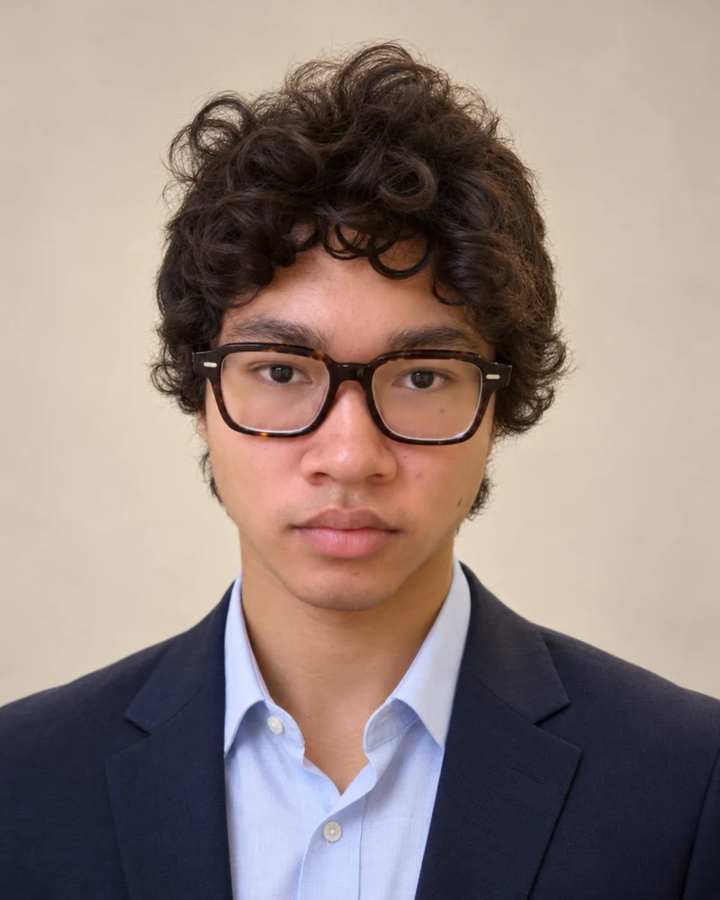Raphael, founder of Raphael Education, wearing glasses and a navy blazer